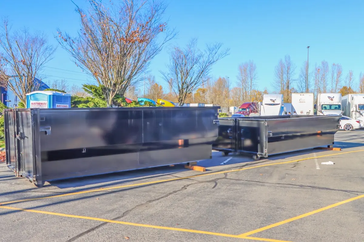 Professional dumpster rental service with roll-off container on residential driveway in Gilberts